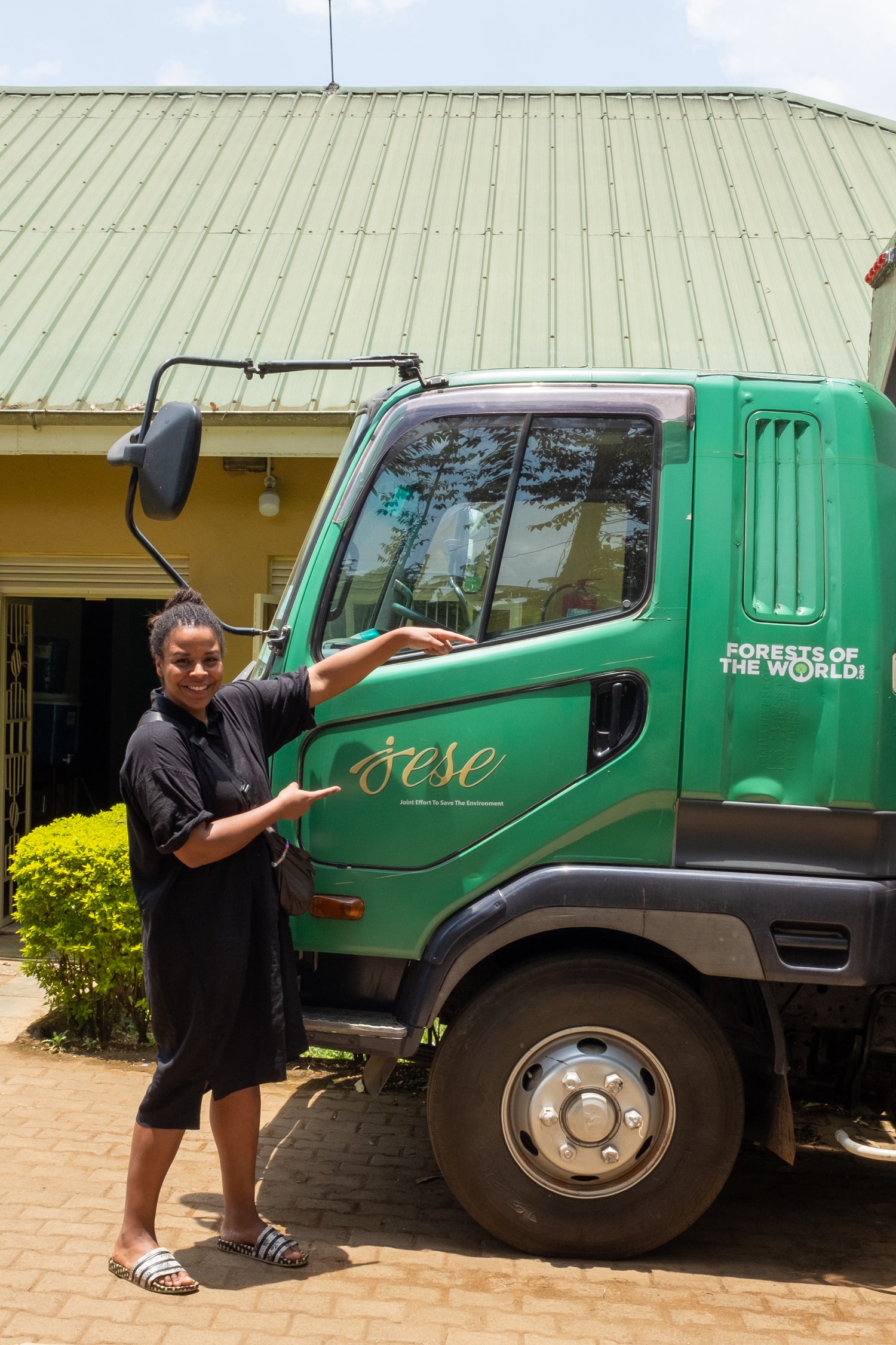 Picture of NGO truck Forest of the World and JESE and a woman